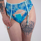 Person wearing a blue floral lingerie against a white background