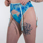 Woman wearing a blue patterned lingerie against a white background
