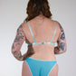 Person wearing a light blue lingerie set against a plain background