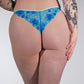 Person wearing blue floral underwear against a plain background