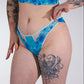 Person wearing blue floral lingerie against a white background