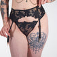 black lace garter belt with chains on a white background