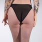 Person wearing sheer black stockings with a plain background